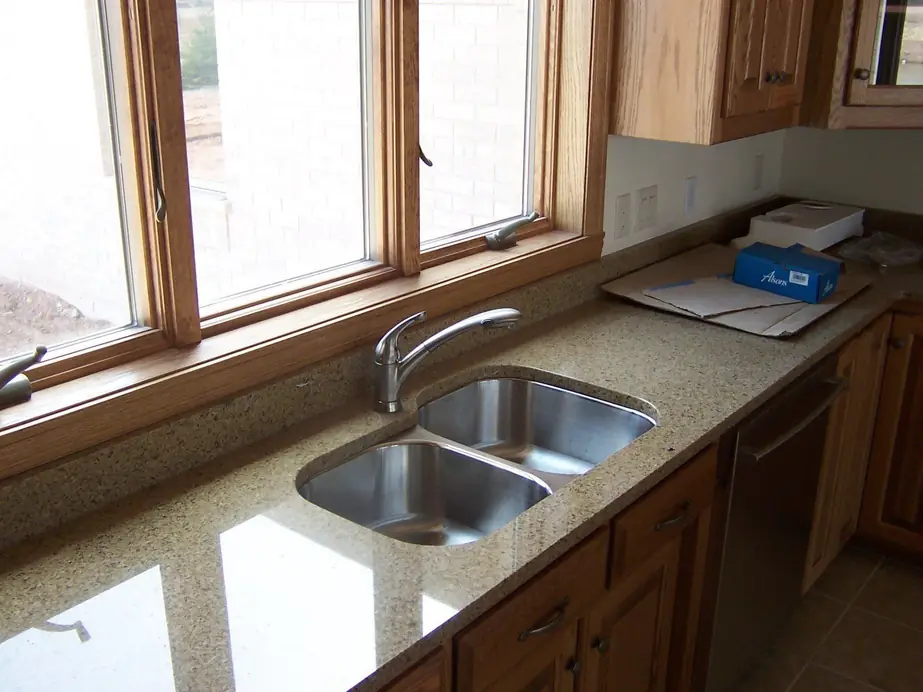 Kitchen undermount double sink with a pull down faucet on a granite counter