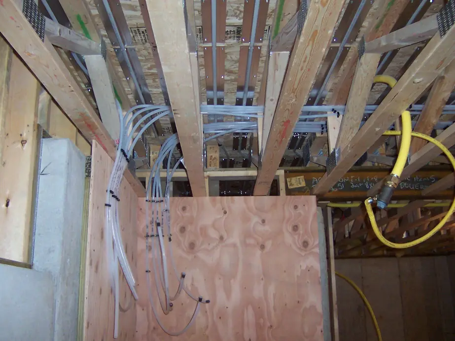 New construction PEX rough in running through floor joists