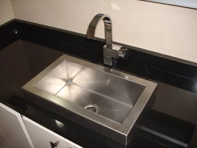 Black granite bar sink with a chrome gooseneck faucet