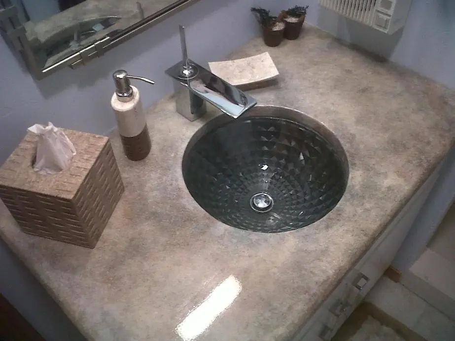Textured glass vessel sink with a waterfall faucet