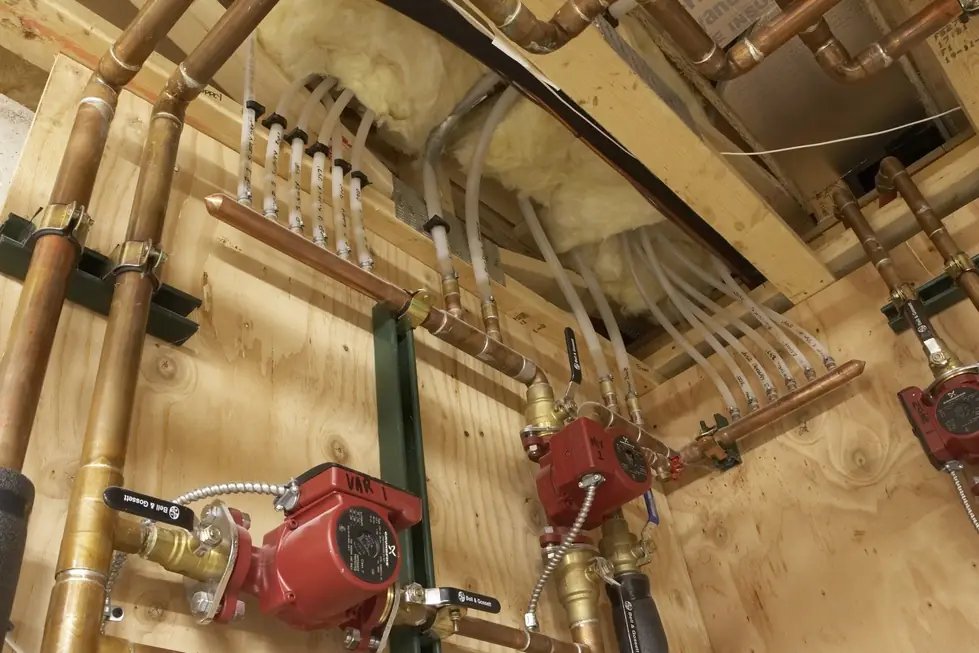 Radiant heat manifold with Grundfos and Bell and Gossett circulator pumps, hand labelled zones